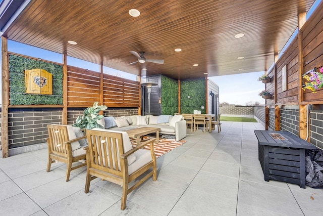 view of patio / terrace featuring an outdoor living space with a fire pit and ceiling fan