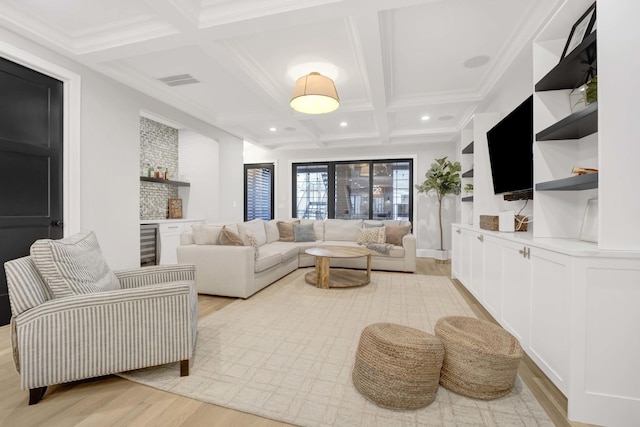 living room featuring light hardwood / wood-style flooring, bar, beam ceiling, coffered ceiling, and beverage cooler