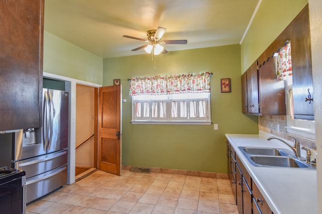 kitchen with decorative backsplash, sink, stainless steel fridge, light tile patterned flooring, and ceiling fan