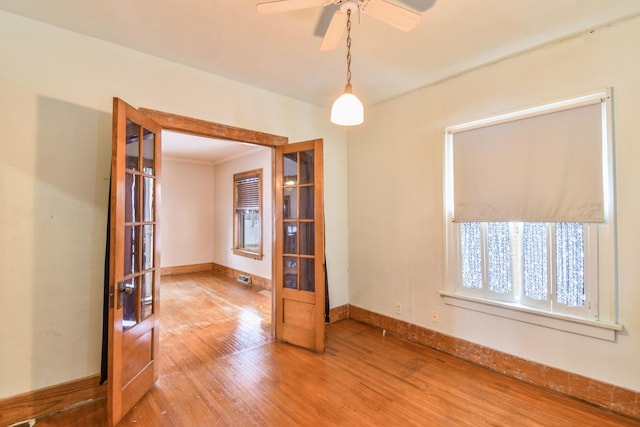 empty room with ceiling fan and hardwood / wood-style flooring