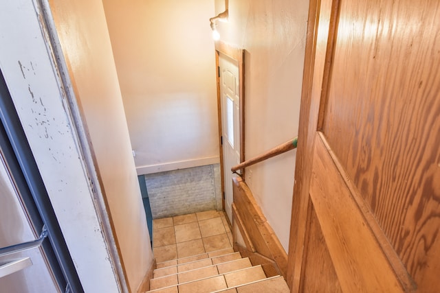 stairway featuring tile patterned floors