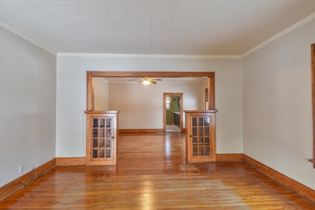 unfurnished room with light hardwood / wood-style floors, crown molding, and ceiling fan