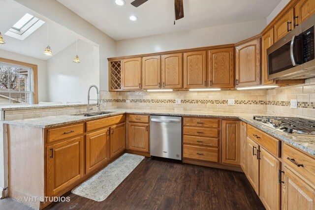 kitchen with pendant lighting, a breakfast bar area, backsplash, kitchen peninsula, and stainless steel appliances