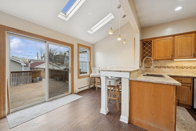 additional living space featuring vaulted ceiling, light colored carpet, and baseboard heating