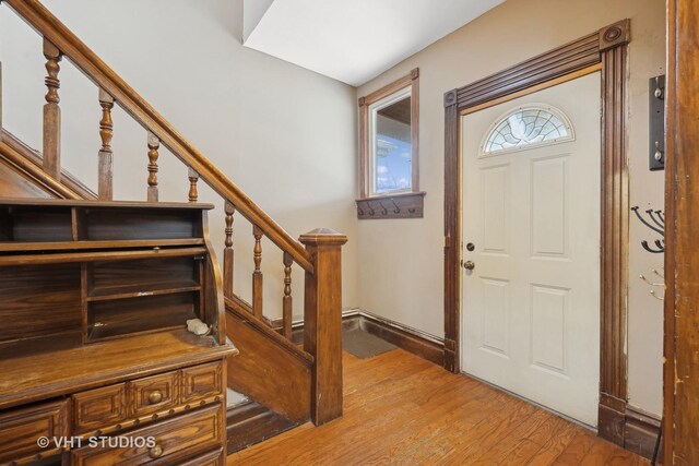 spare room with radiator, ceiling fan, a healthy amount of sunlight, and light wood-type flooring