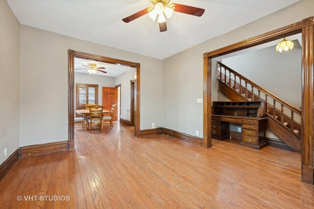 dining area with hardwood / wood-style flooring, ceiling fan, and radiator heating unit