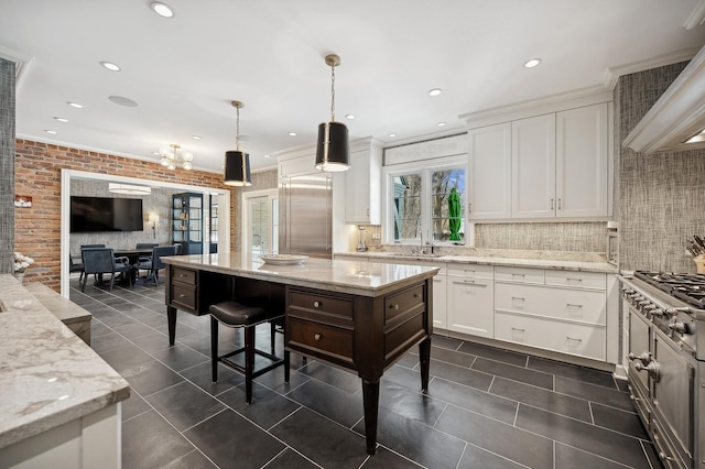 kitchen with brick wall, stainless steel appliances, a sink, white cabinetry, and ventilation hood