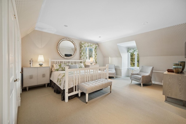 carpeted bedroom featuring vaulted ceiling, baseboards, and wallpapered walls