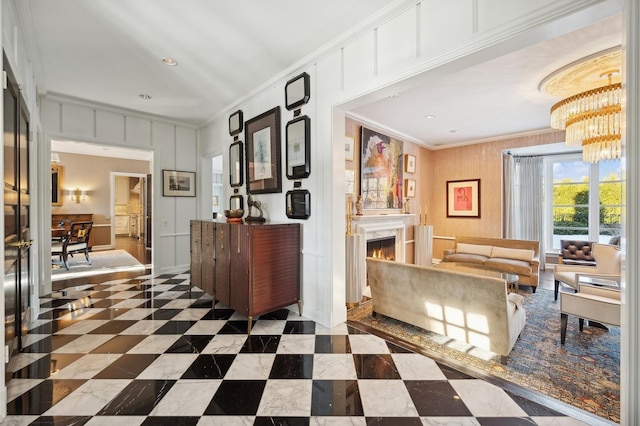 interior space featuring a warm lit fireplace and a notable chandelier