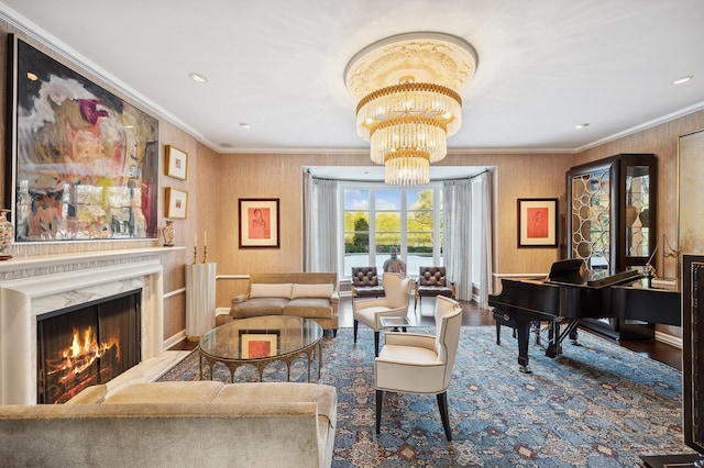 sitting room featuring ornamental molding, wood finished floors, a fireplace, a chandelier, and recessed lighting