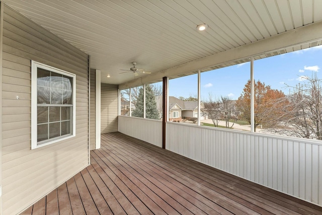 unfurnished sunroom featuring ceiling fan