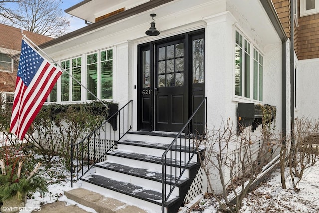 view of snow covered property entrance