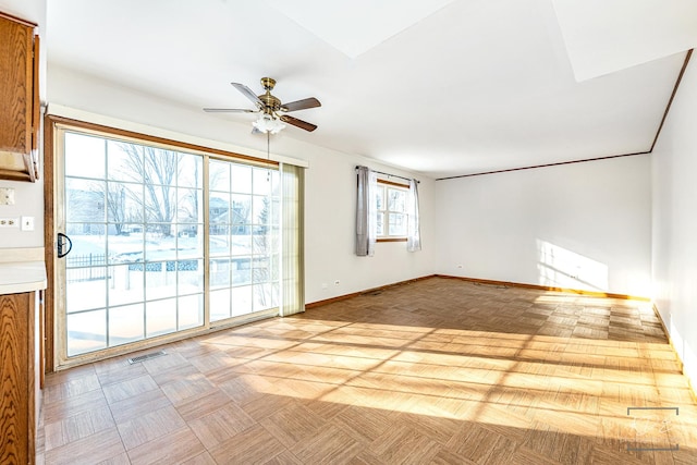 unfurnished living room with ceiling fan and light parquet flooring