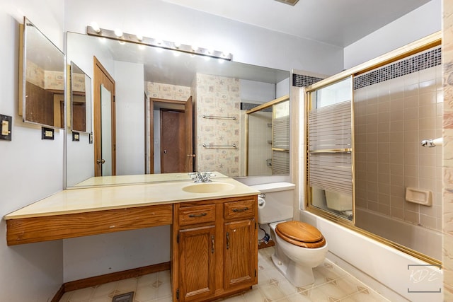 full bathroom with toilet, vanity, and shower / bath combination with glass door