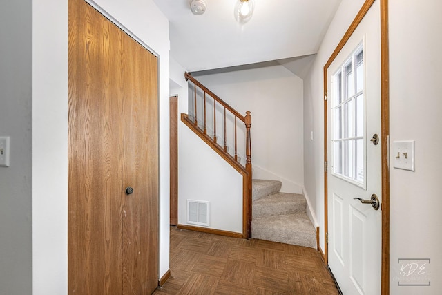 foyer featuring dark parquet flooring