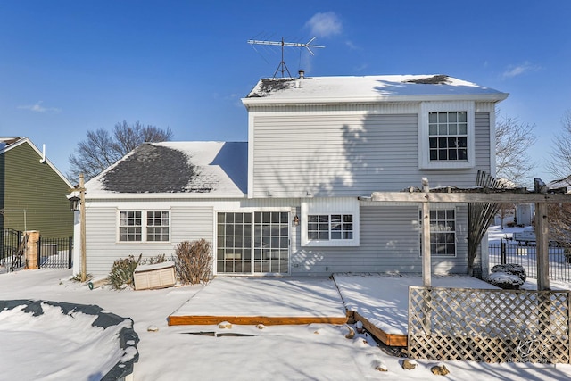 snow covered property featuring a pergola and a wooden deck