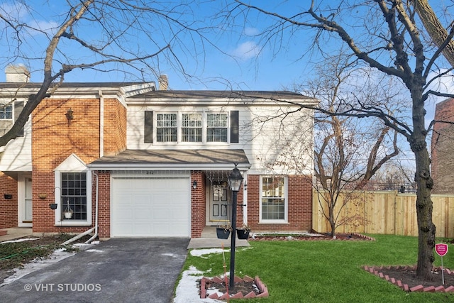 view of front of home with a front yard and a garage