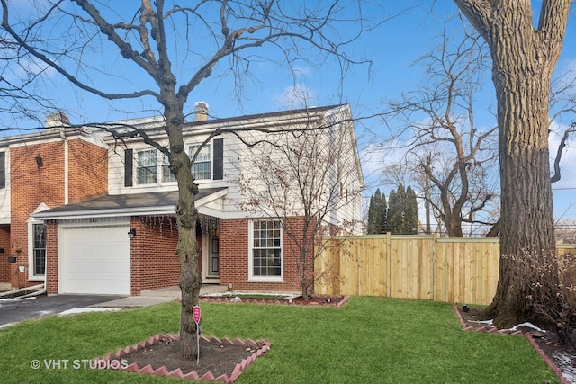 view of front of home featuring a front yard and a garage