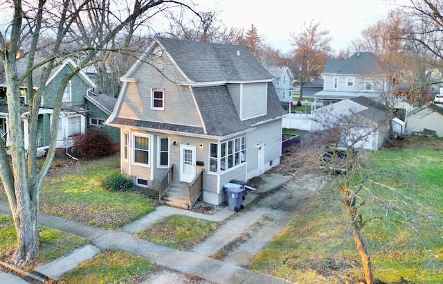 view of front of property with entry steps, roof with shingles, and a gambrel roof