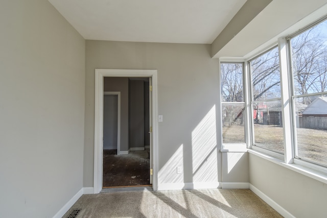 interior space with carpet flooring, visible vents, and baseboards