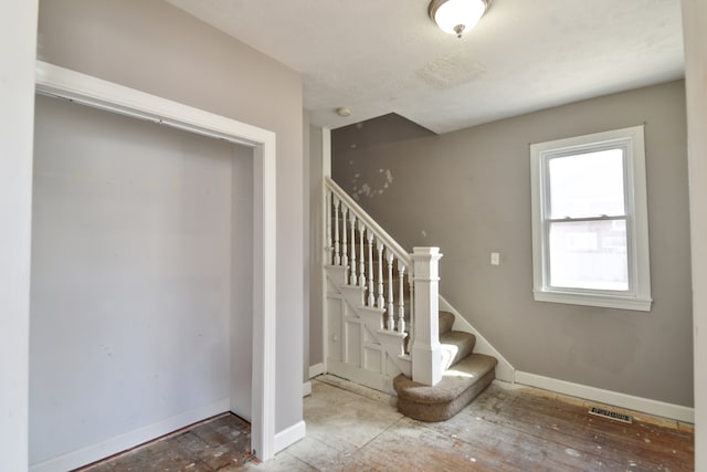 staircase featuring visible vents and baseboards