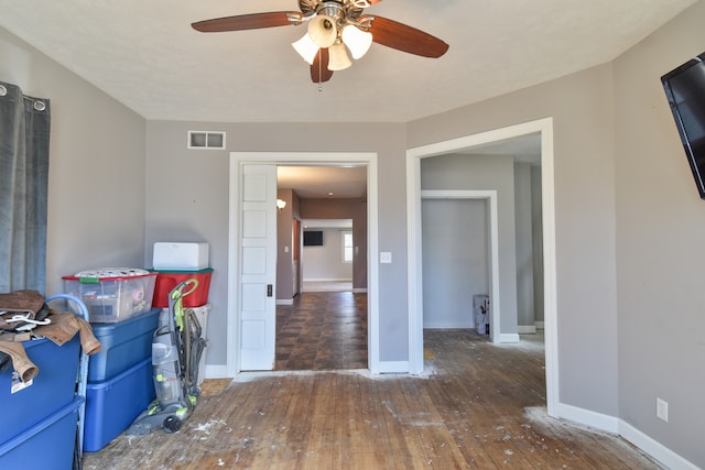 unfurnished room featuring visible vents, baseboards, and hardwood / wood-style flooring