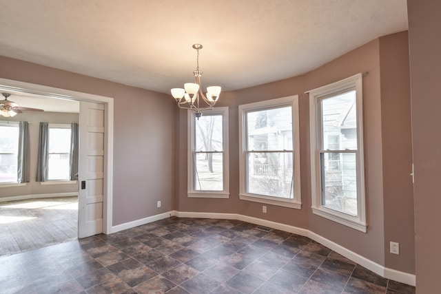 unfurnished room featuring visible vents, baseboards, and ceiling fan with notable chandelier