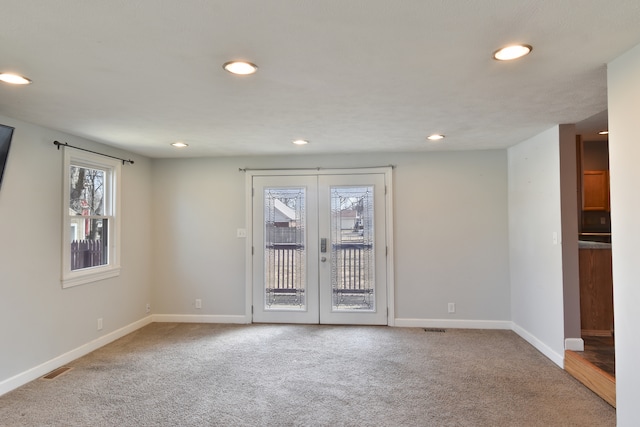 carpeted empty room with recessed lighting, french doors, visible vents, and baseboards