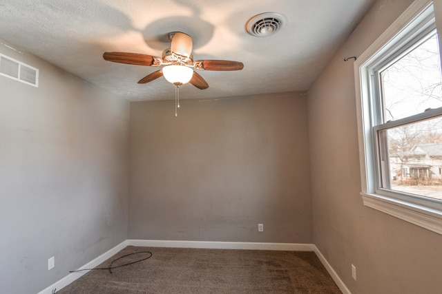 spare room featuring a ceiling fan, carpet, visible vents, and baseboards