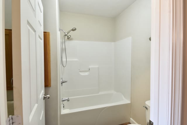 bathroom featuring toilet and  shower combination