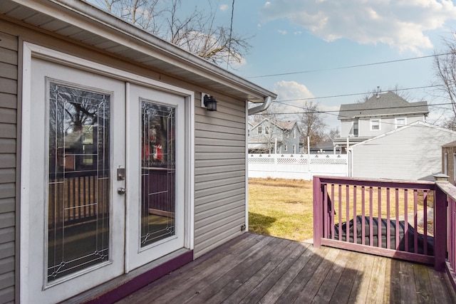 wooden terrace featuring fence and a yard