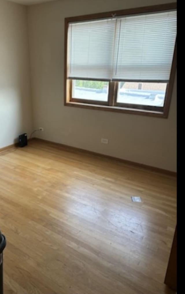 spare room with light wood-type flooring