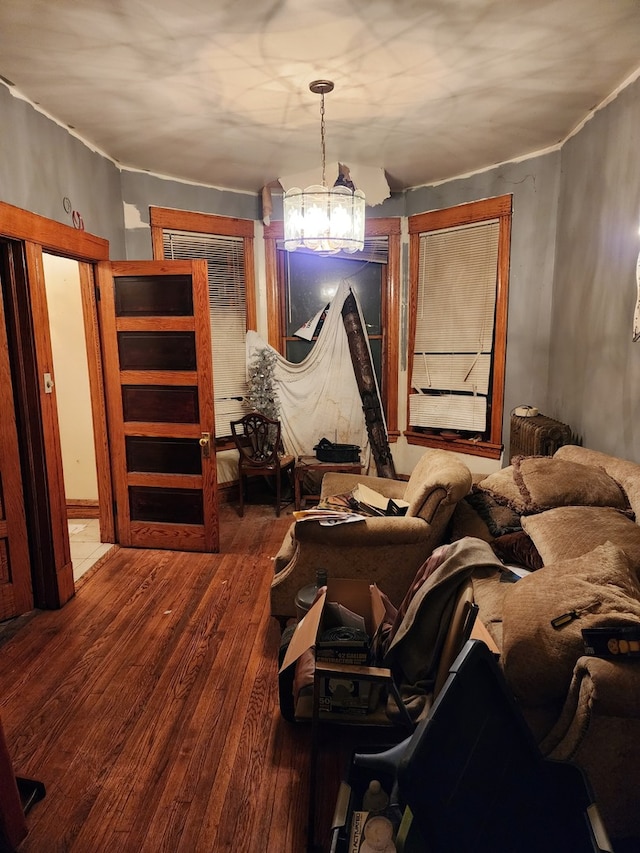 bedroom with a chandelier and wood finished floors