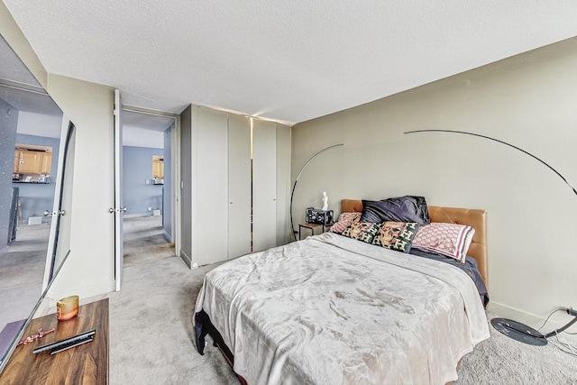 carpeted bedroom with a textured ceiling