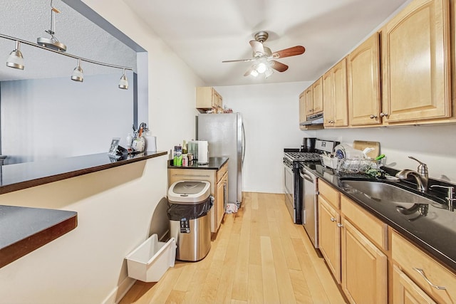 kitchen with stainless steel appliances, light hardwood / wood-style floors, sink, light brown cabinetry, and ceiling fan