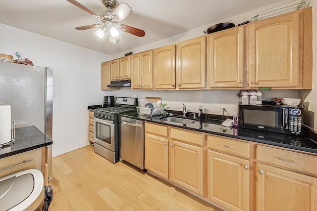 kitchen featuring sink, light brown cabinets, stainless steel appliances, and light hardwood / wood-style floors