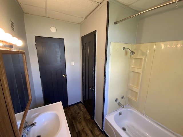 bathroom with vanity, shower / tub combination, a paneled ceiling, and hardwood / wood-style flooring