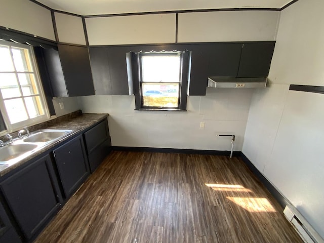 kitchen with dark wood-type flooring, sink, and a baseboard heating unit