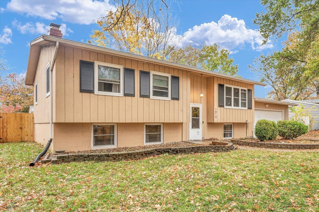 split foyer home with a front yard and a garage