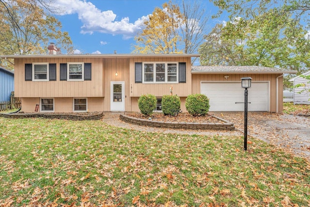 bi-level home with a front yard and a garage