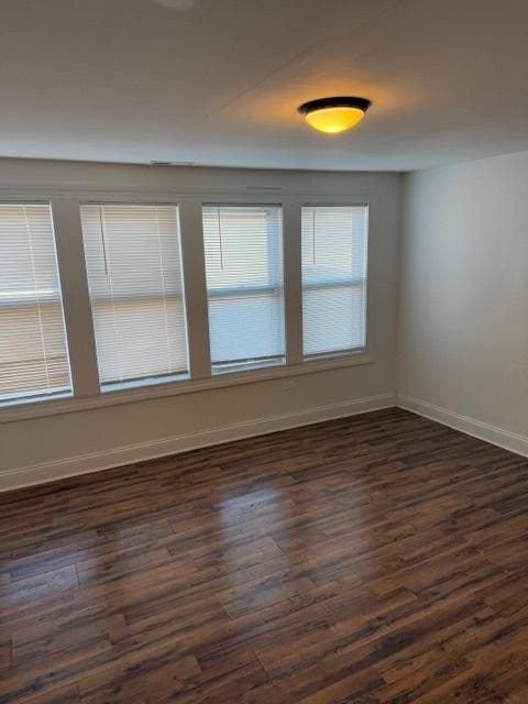 spare room featuring dark hardwood / wood-style flooring