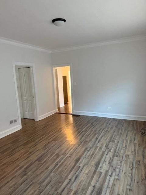 unfurnished room featuring dark hardwood / wood-style flooring and crown molding