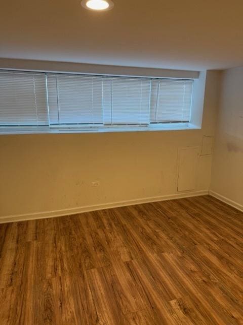 spare room with wood-type flooring