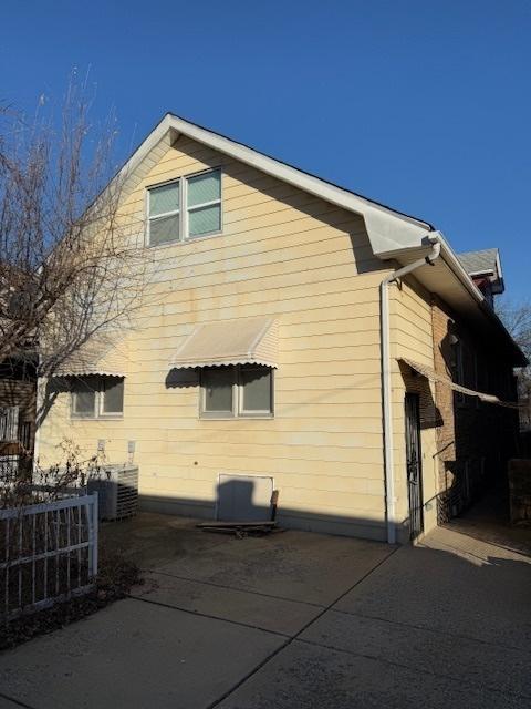 view of side of home featuring cooling unit