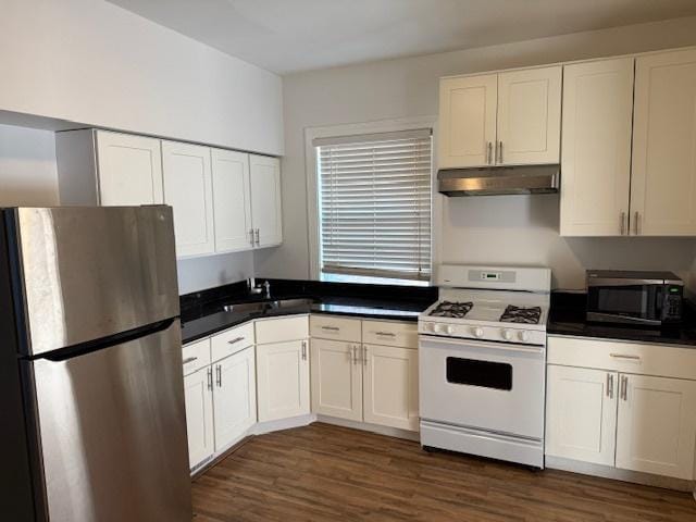 kitchen featuring dark wood-type flooring, white cabinets, appliances with stainless steel finishes, and sink