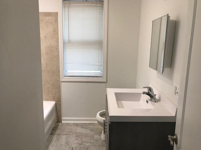 full bathroom featuring toilet, tub / shower combination, and vanity