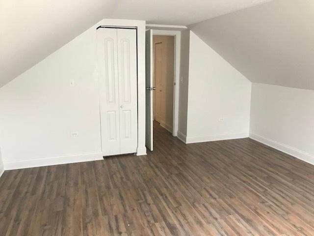 bonus room featuring dark wood-type flooring and lofted ceiling