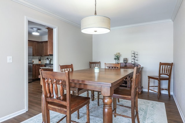 dining room with ornamental molding and dark hardwood / wood-style floors