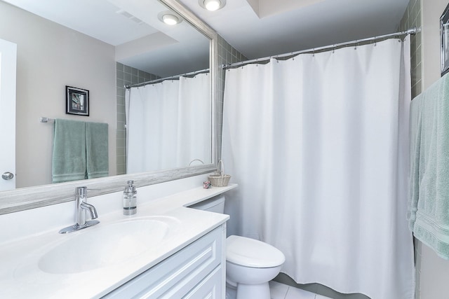 bathroom featuring toilet, vanity, and tile patterned flooring