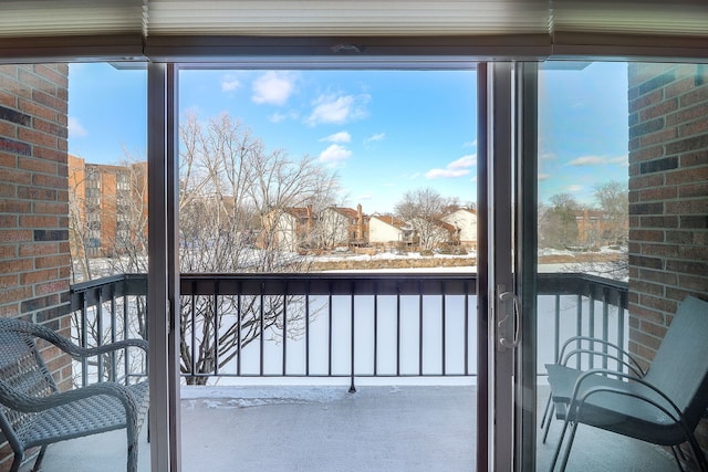 view of snow covered back of property